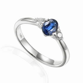 18ct White Gold 0.73ct Oval Cut Blue Sapphire And 0.13ct Round Brilliant Cut Diamond Three Stone Ring