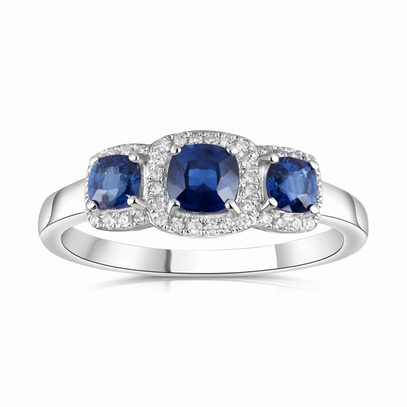 18ct White Gold 0.75ct Cushion Cut Blue Sapphire Three Stone Ring With 0.11ct Diamond Halo