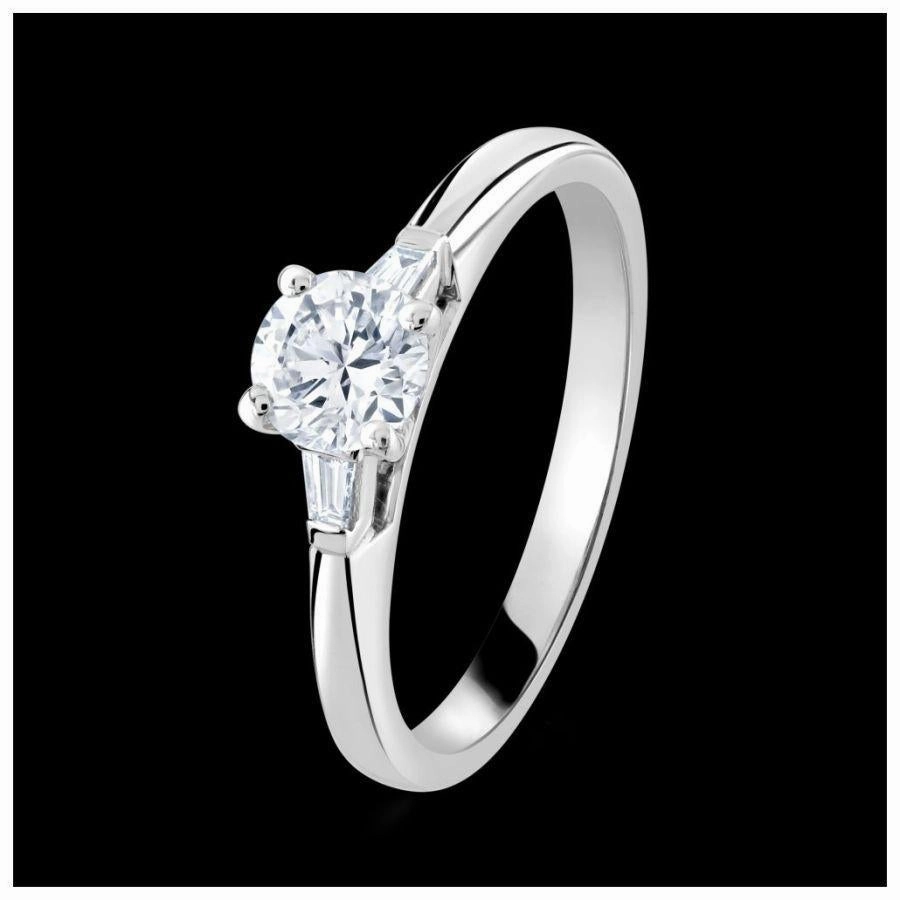 Platinum 4-claw set round brilliant cut Diamond solitaire ring with two tapered Diamonds