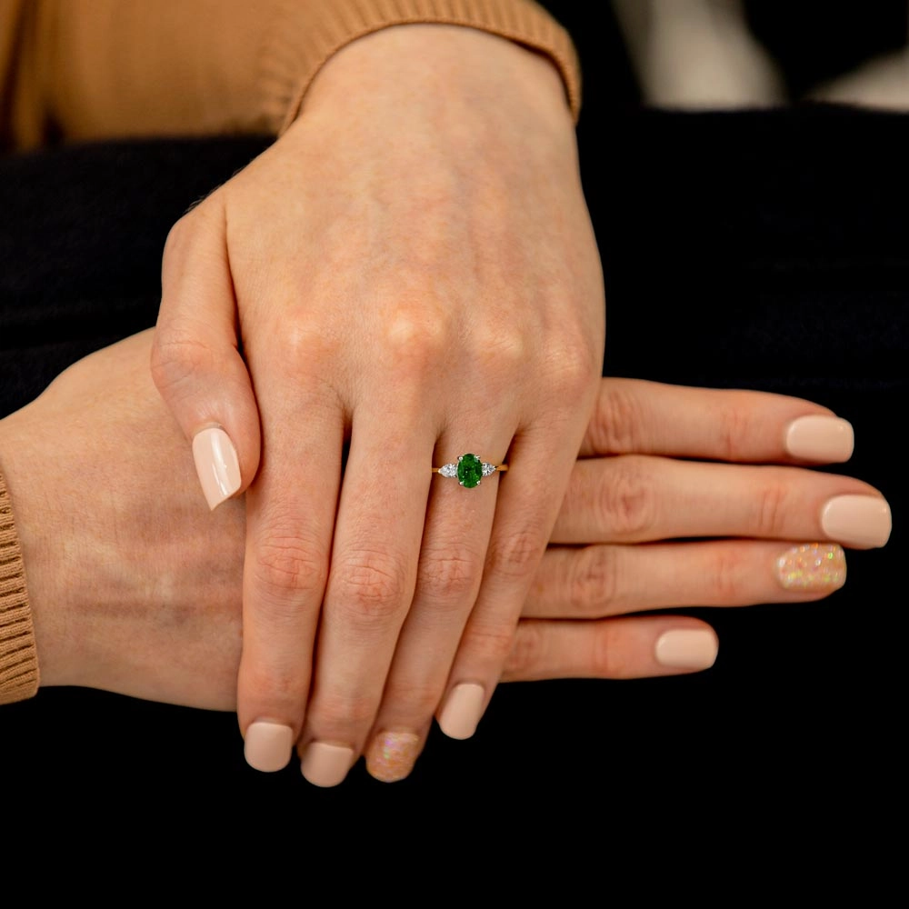 Platinum And 18ct Yellow Gold 0.78ct Oval Cut Emerald And 0.27ct Pear Cut Diamond Three Stone Engagement Ring