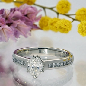 Platinum Certificated 0.70ct Oval Diamond Solitaire Ring with Princess Cut Shoulders