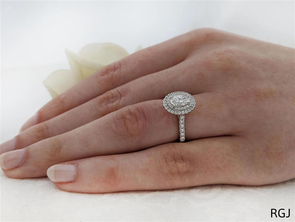 The Faroe Duo Platinum 0.63ct Oval Cut Diamond Engagement Ring With 0.41ct Scalloped Double Diamond Halo And Diamond Set Shoulders