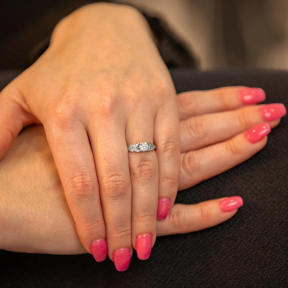 The Fleur Platinum Round Brilliant Cut Diamond Solitaire Engagement Ring With Diamond Leaf Detailing