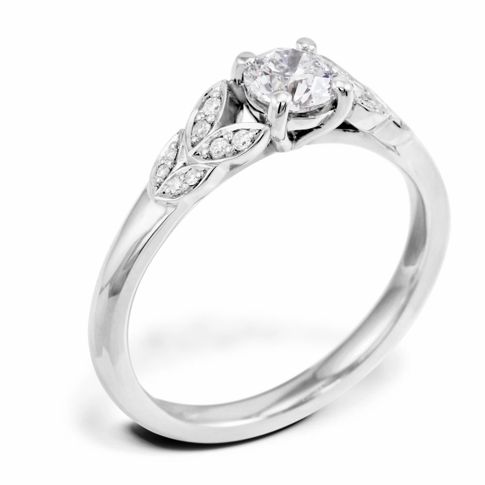 The Fleur Platinum Round Brilliant Cut Diamond Solitaire Engagement Ring With Diamond Leaf Detailing