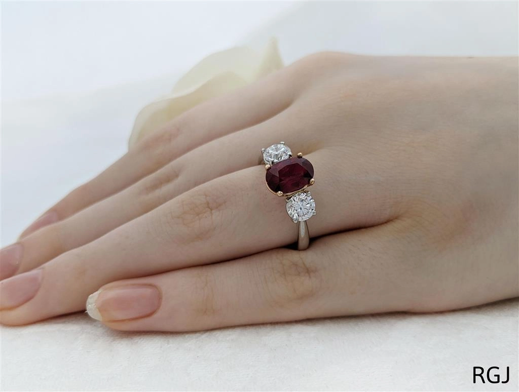 The Florentina Iconic Platinum And 18ct Rose Gold 2.04ct Oval Cut Ruby And 1.01ct Round Brilliant Cut Diamond Three Stone Ring With 0.08ct Diamond Detailing