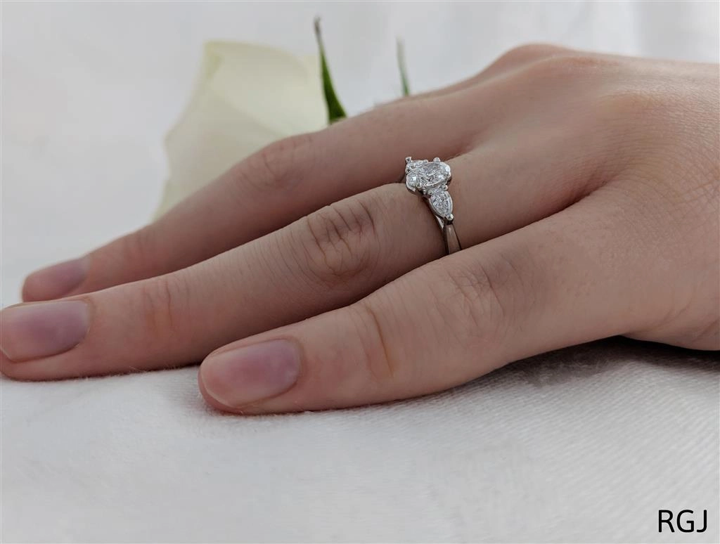The Florentine Platinum 0.30ct Oval And 0.20ct Pear Cut Diamond Three Stone Engagement Ring