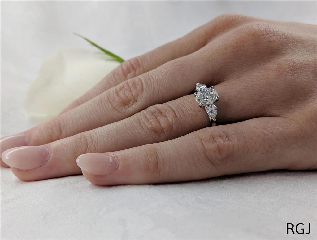 The Florentine Platinum 0.70ct Oval And 0.40ct Pear Cut Diamond Three Stone Engagement Ring