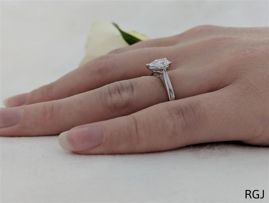 The Oxford Platinum 0.70ct Pear Cut Diamond Solitaire Engagement Ring With 0.07ct Diamond Detailing