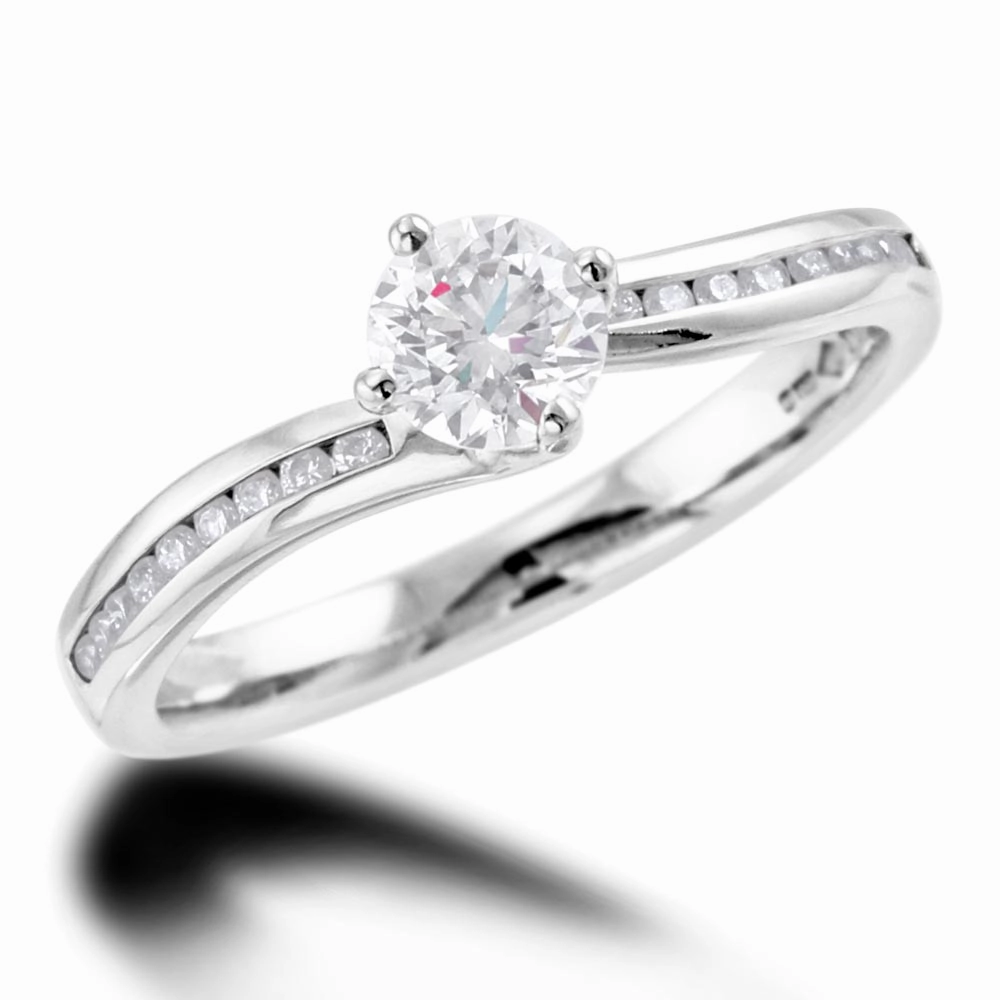 The Rose Platinum Round Brilliant Cut Diamond Solitaire Engagement Ring With Channel Set Diamond Shoulders