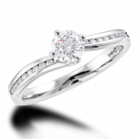 The Rose Platinum Round Brilliant Cut Diamond Solitaire Engagement Ring With Channel Set Diamond Shoulders