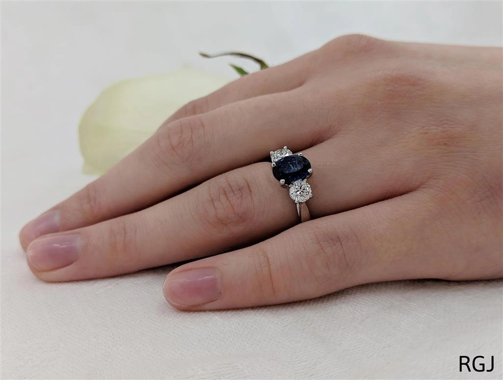 The Royal Platinum 1.48ct Oval Cut Blue Sapphire And 0.58ct Round Brilliant Cut Diamond Three Stone Ring