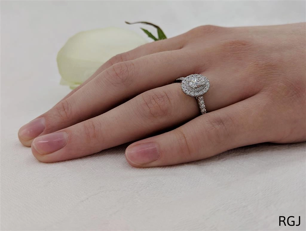 The Skye Duo Platinum 0.30ct Oval Cut Diamond Engagement Ring With 0.40ct Double Diamond Halo And Diamond Set Shoulders