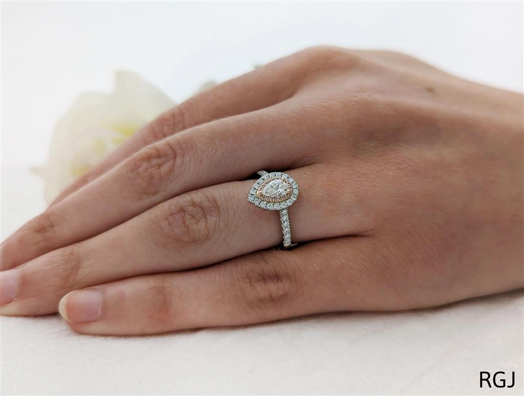 The Skye Duo Platinum And 18ct Rose Gold 0.31ct Pear Cut Diamond Engagement Ring With 0.35ct Pink And White Diamond Halo And Diamond Set Shoulders