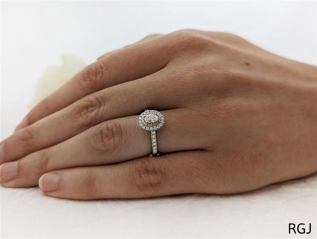 The Skye Duo Platinum And 18ct Rose Gold 0.38ct Oval Cut Diamond Engagement Ring With 0.34ct Pink And White Diamond Halo And Diamond Set Shoulders