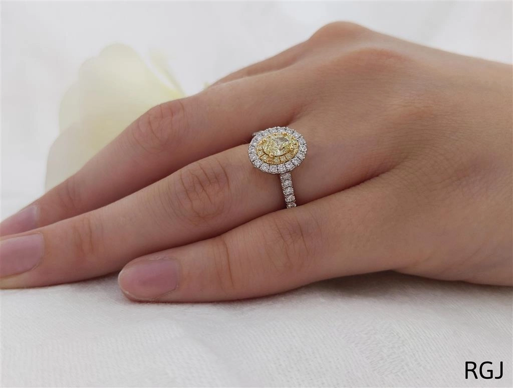 The Skye Duo Platinum And 18ct Yellow Gold 0.54ct Oval Cut Yellow Diamond Engagement Ring With 0.47ct Yellow And White Diamond Halo And Diamond Set Shoulders