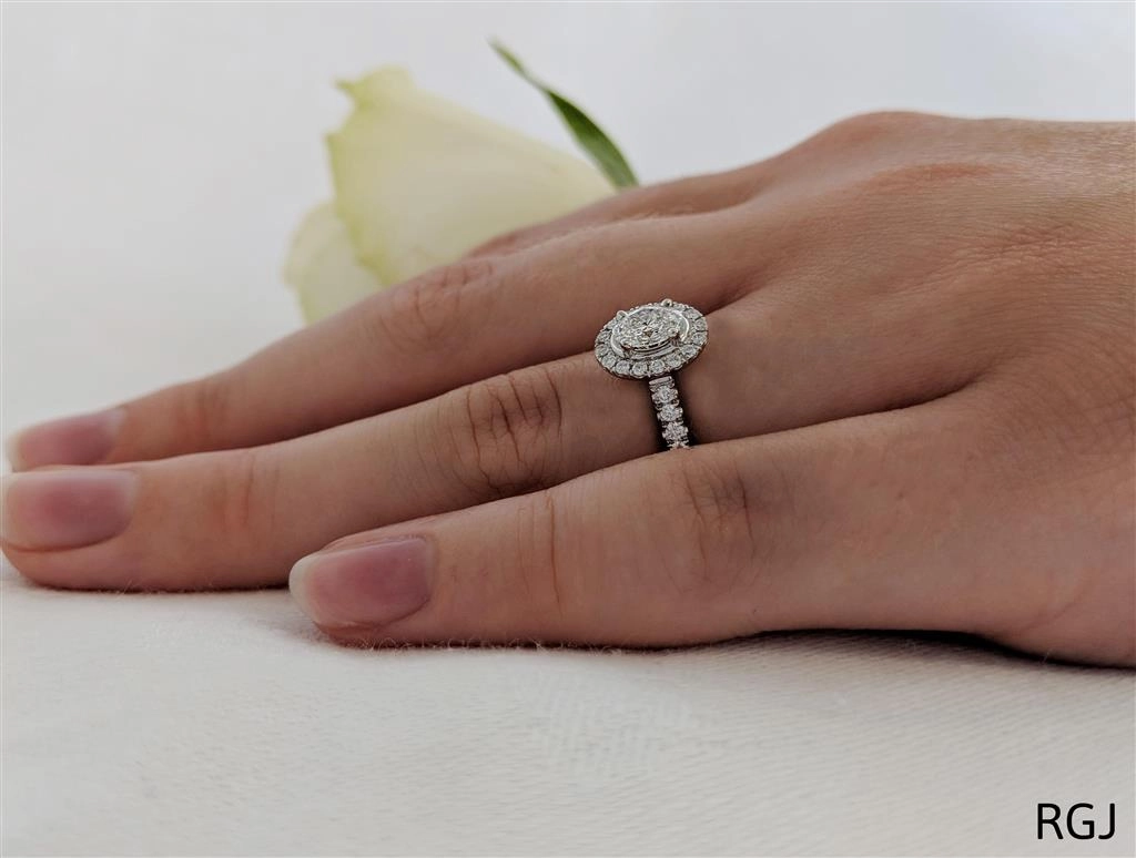 The Skye Platinum 0.40ct Oval Cut Diamond Engagement Ring With 0.31ct Diamond Halo And Diamond Set Shoulders