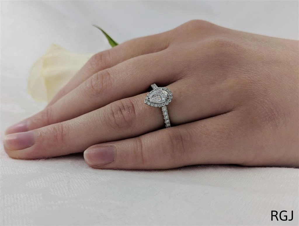 The Skye Platinum 0.44ct Pear Cut Diamond Engagement Ring With 0.33ct Diamond Halo And Diamond Set Shoulders