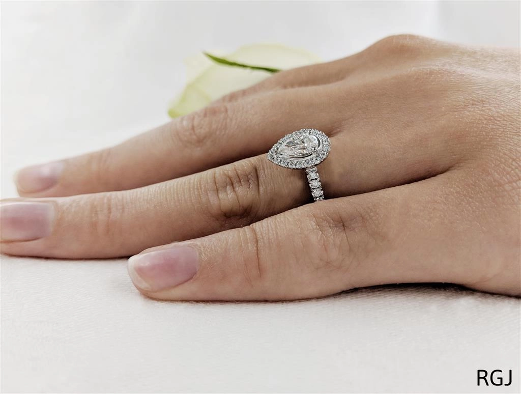 The Skye Platinum 0.50ct Pear Cut Diamond Engagement Ring With 0.33ct Diamond Halo And Diamond Set Shoulders