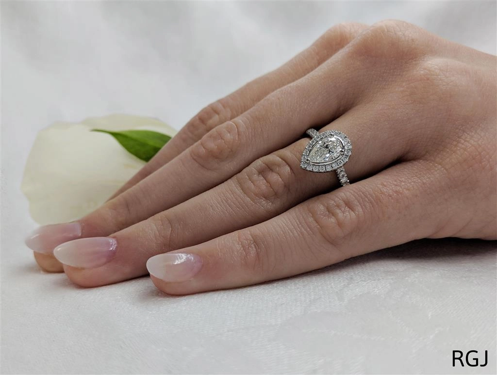 The Skye Platinum 0.70ct Pear Cut Diamond Engagement Ring With 0.39ct Diamond Halo And Diamond Set Shoulders