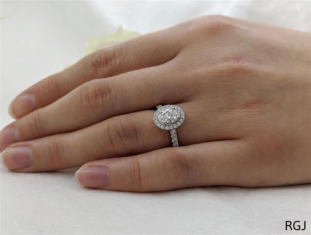 The Skye Platinum 0.72ct Oval Cut Diamond Engagement Ring With 0.35ct Diamond Halo And Diamond Set Shoulders