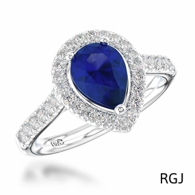 The Skye Platinum 0.76ct Pear Cut Blue Sapphire Ring With 0.33ct Diamond Halo And Diamond Set Shoulders