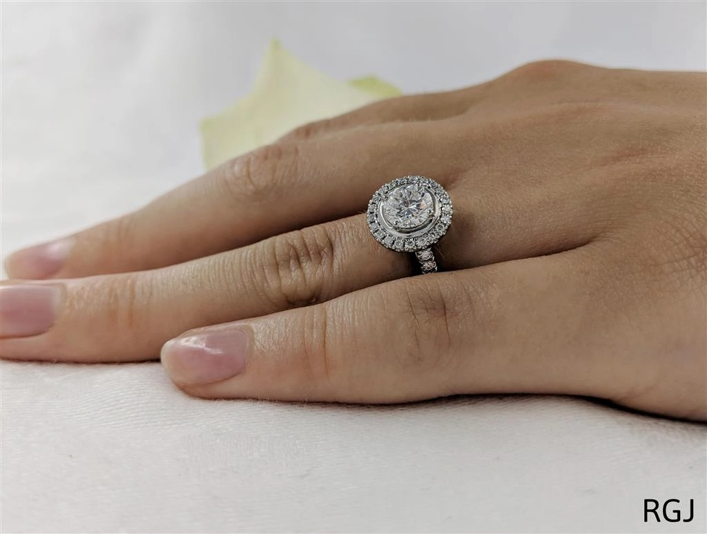 The Skye Platinum 0.80ct Round Brilliant Cut Diamond Engagement Ring With 0.39ct Diamond Halo And Diamond Set Shoulders