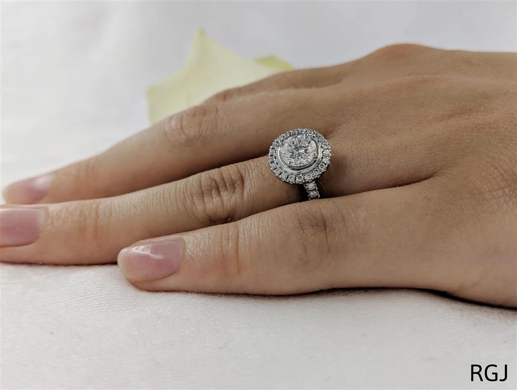 The Skye Platinum 0.90ct Round Brilliant Cut Diamond Engagement Ring With 0.39ct Diamond Halo And Diamond Set Shoulders