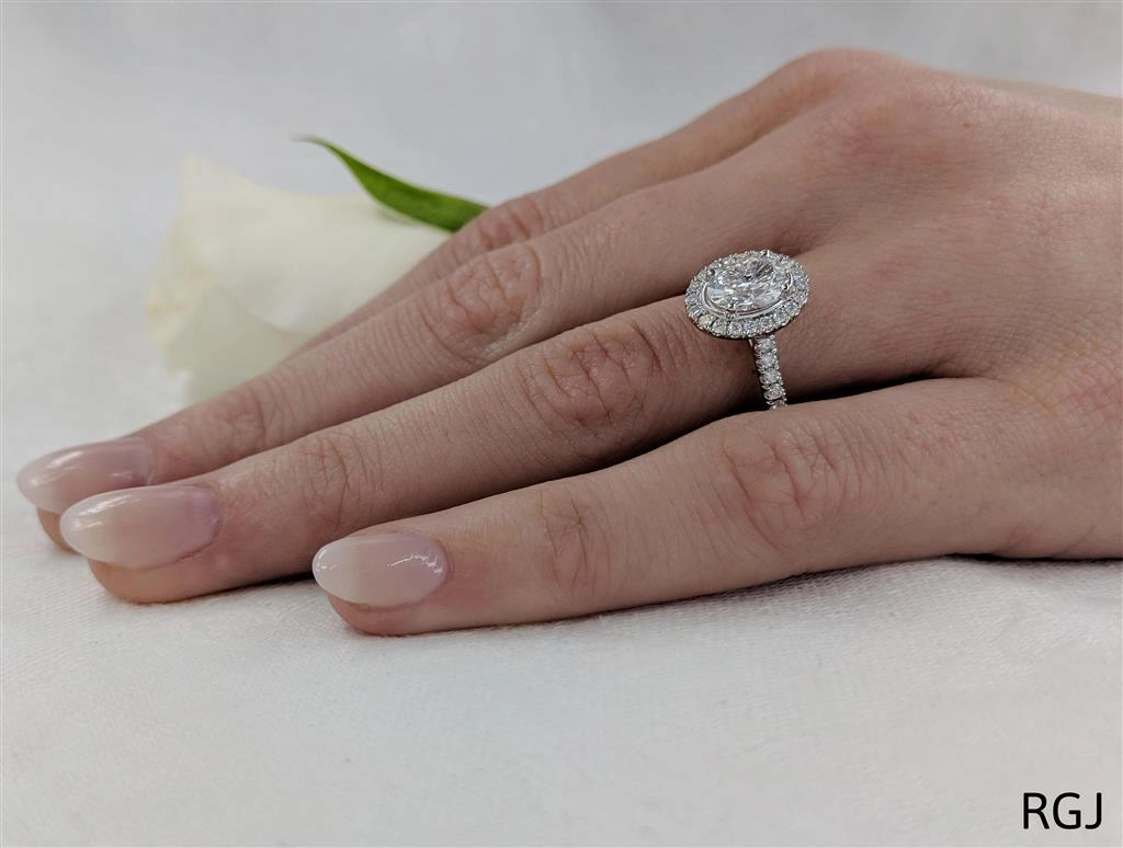 The Skye Platinum 0.91ct Oval Cut Diamond Engagement Ring With 0.39ct Diamond Halo And Diamond Set Shoulders