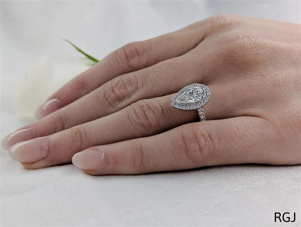 The Skye Platinum 1.53ct Pear Cut Diamond Engagement Ring With 0.42ct Diamond Halo And Diamond Set Shoulders