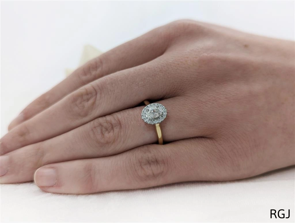The Skye Pure 18ct Yellow Gold And Platinum 0.50ct Oval Cut Diamond Engagement Ring With 0.15ct Diamond Halo