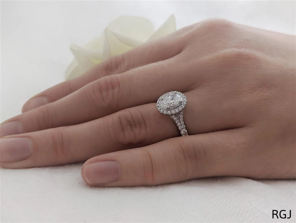 The Skye Saturn Platinum 0.51ct Oval Cut Diamond Solitaire Engagement Ring With 0.30ct Diamond Halo And Diamond Set Split Shoulders
