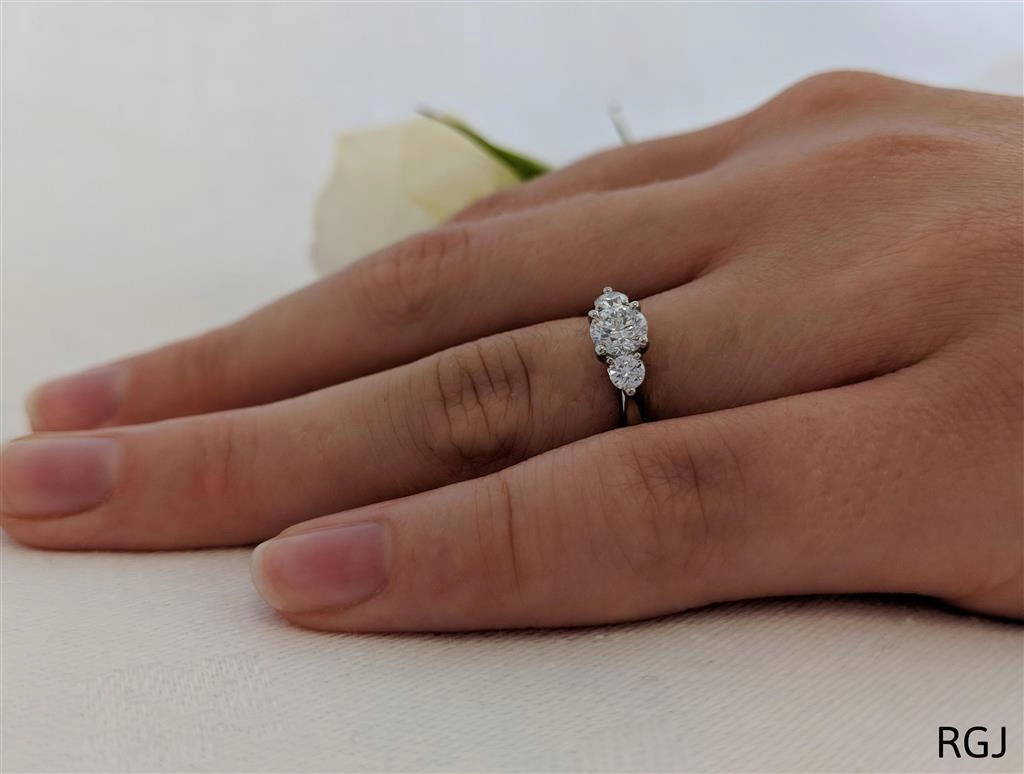 The Tulip Platinum 0.60ct Round Brilliant Cut Diamond Three Stone Engagement Ring