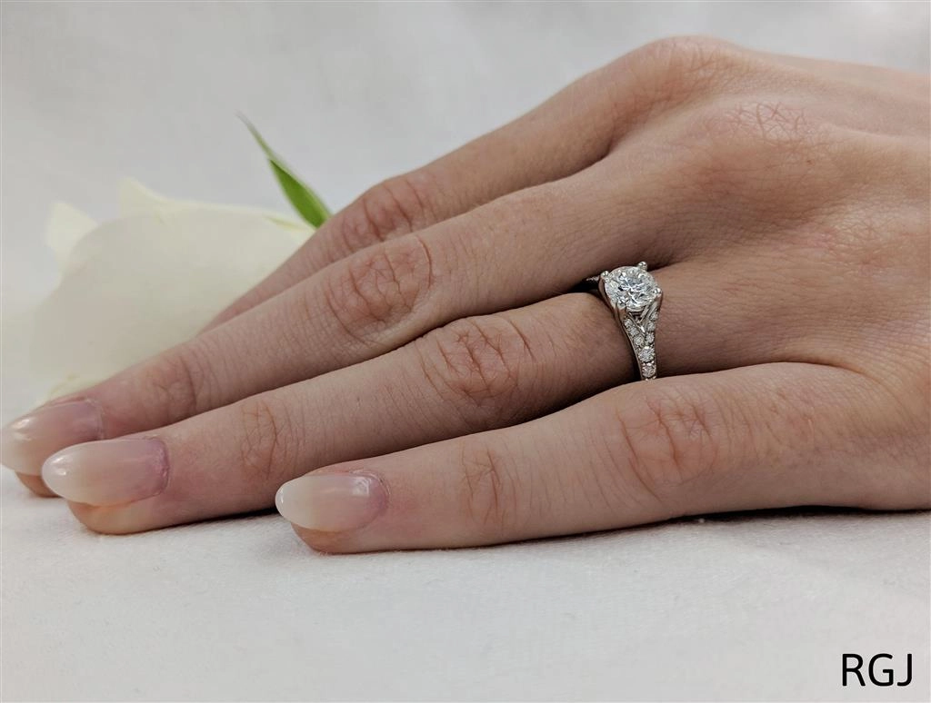 The Valentia Platinum 0.70ct Round Brilliant Cut Diamond Solitaire Engagement Ring With 0.24ct Diamond Set Shoulders
